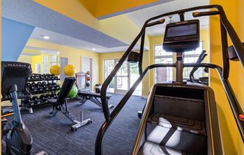 a gym with weights and cardio equipment at the monarch apartments in midtown